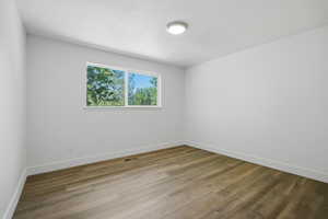 Unfurnished room with baseboards and light wood finished floors