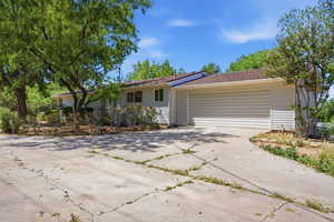 Single story home with driveway and a garage