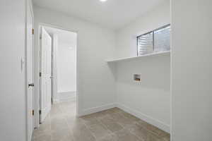 Laundry room featuring washer hookup and light tile patterned floors