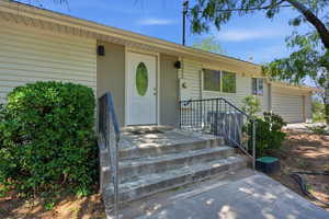 View of exterior entry featuring a garage