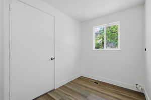 Spare room with wood finished floors and baseboards