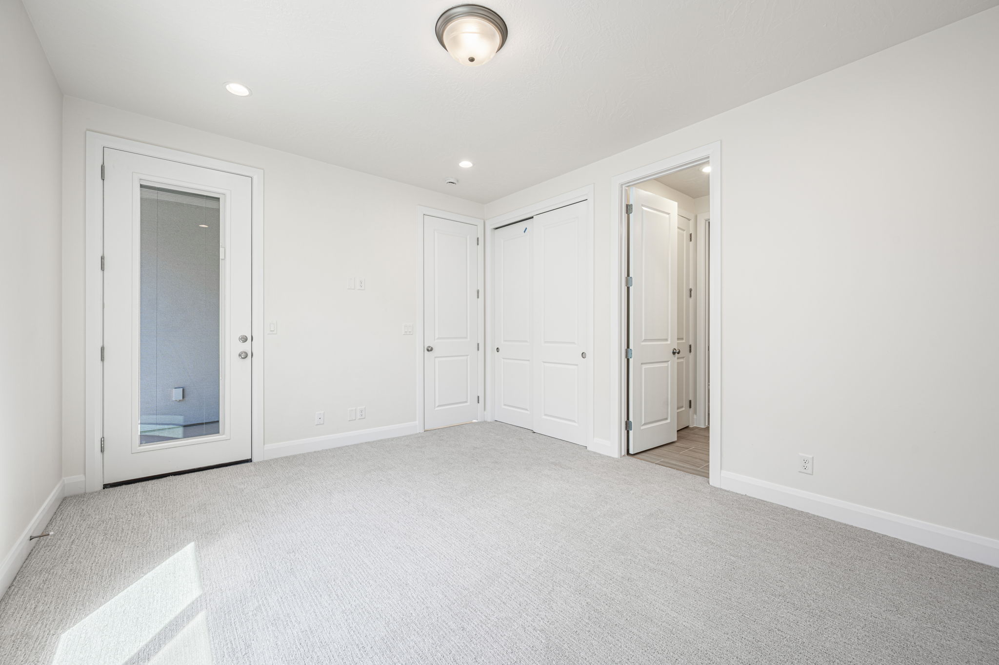 Carpeted room with recessed lighting and a flush mount ceiling fixture