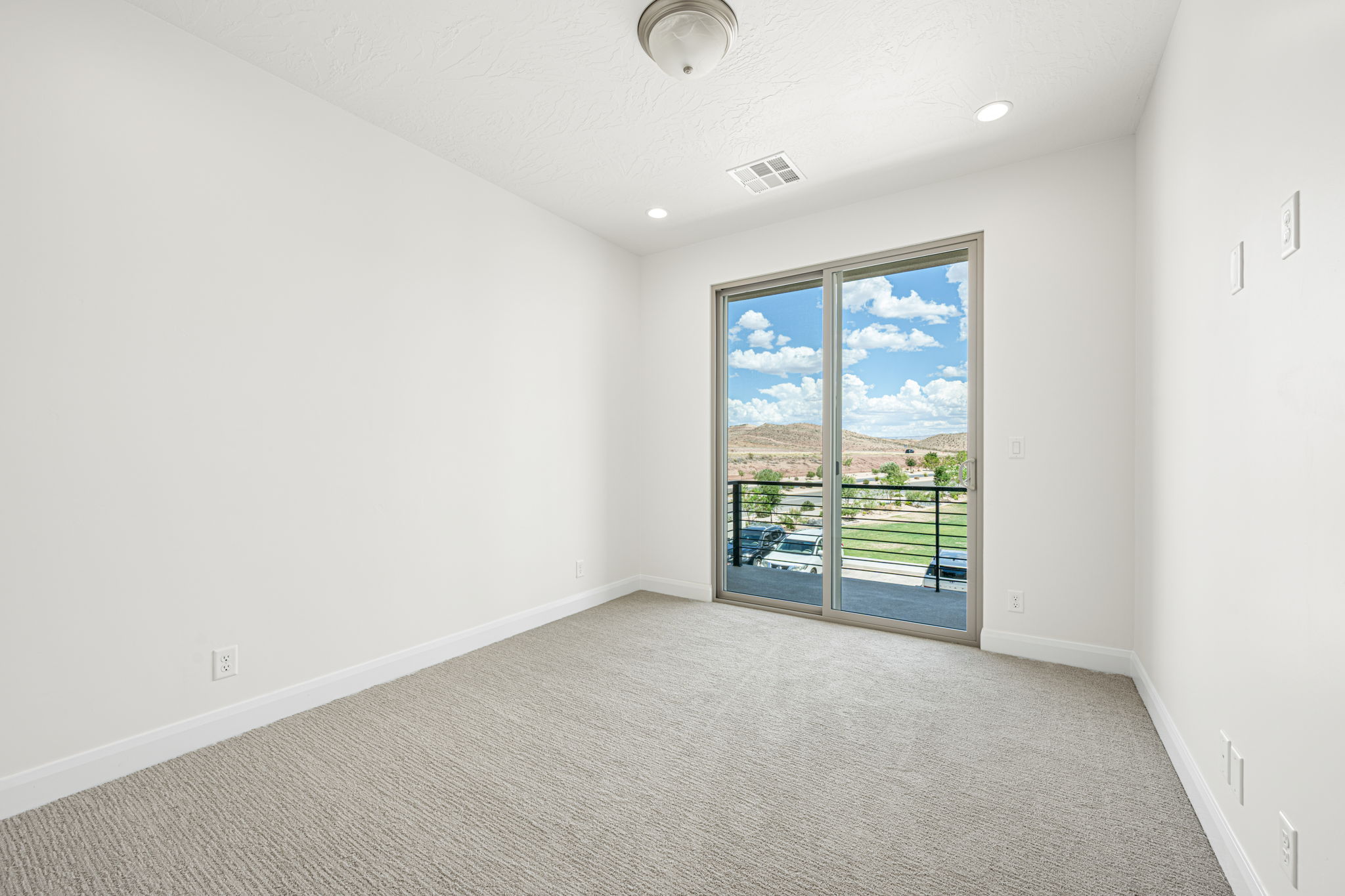 Expansive sliding glass doors provide broad natural light and mountain scenery