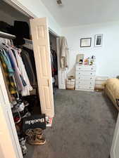 Bedroom featuring a closet and dark carpet