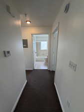 Hall with dark carpet and electric panel