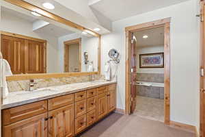 Full bathroom featuring a bath, double vanity, recessed lighting, light carpet, and light tile patterned floors