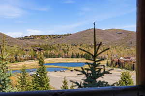 View of swimming pool with a water and mountain view