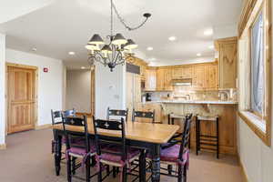 Dining room featuring a chandelier and light carpet
