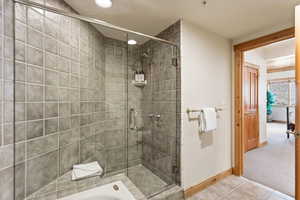 Bathroom featuring a shower stall, recessed lighting, light tile patterned floors, light colored carpet, and a tub
