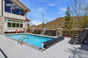 View of swimming pool with a mountain view and patio surround