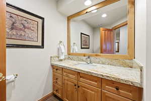 Bathroom featuring vanity and baseboards
