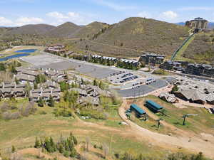 Aerial view of property's location featuring a mountain backdrop and nearby suburban area