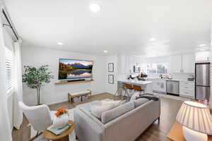 Living area featuring light wood-style floors and recessed lighting