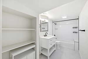 Bathroom featuring vanity and shower / washtub combination