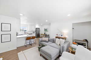 Living area featuring light wood-type flooring and recessed lighting