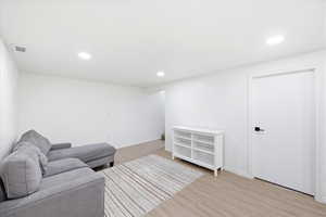Sitting room featuring light wood-type flooring and recessed lighting