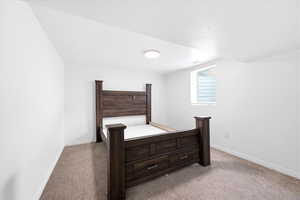 Bedroom with light colored carpet