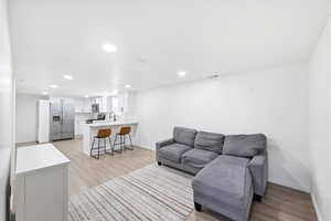 Living room featuring light wood-style floors and recessed lighting