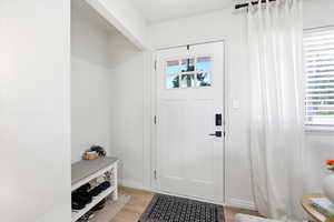 Entryway featuring light wood-type flooring and a barn door