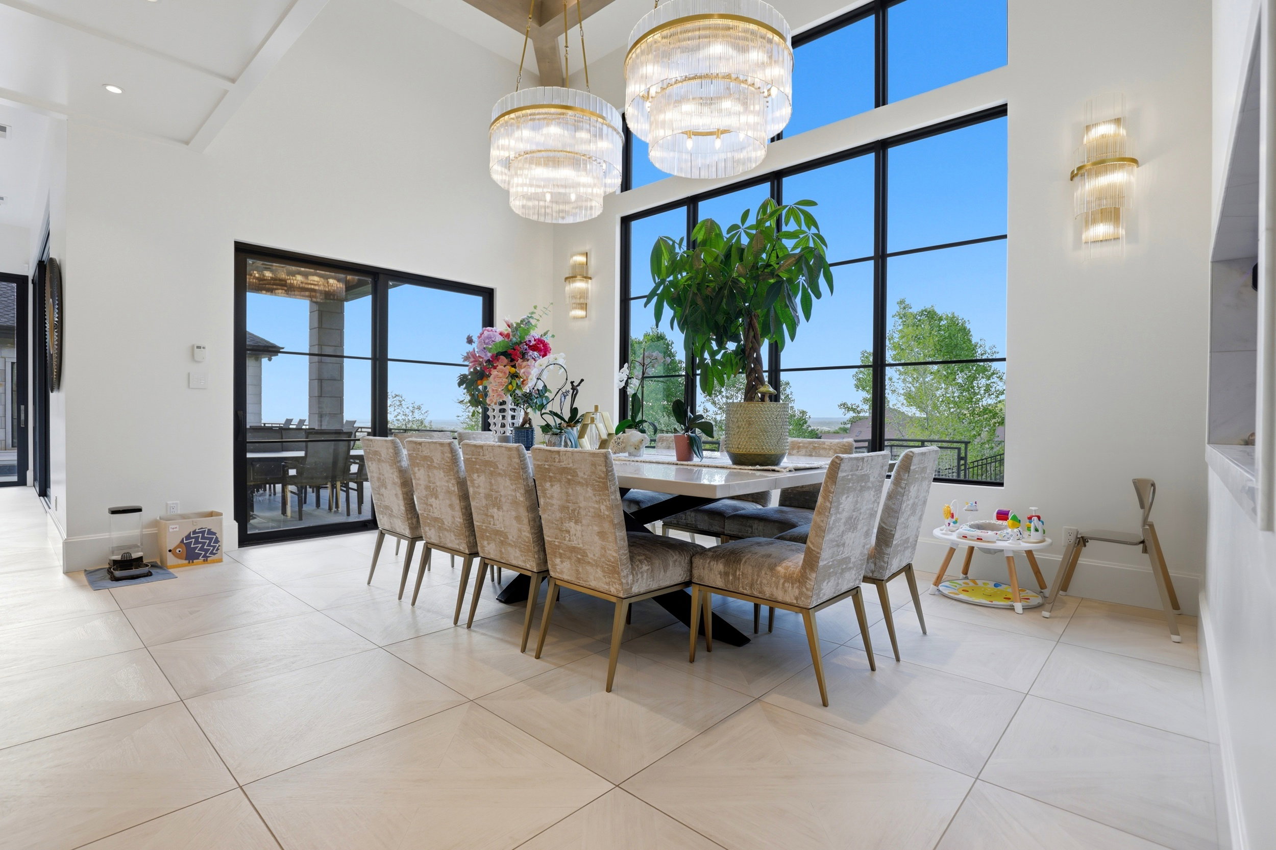 Dining area featuring a high ceiling, a chandelier, and light tile patterned floors