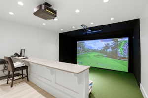 Cinema room featuring golf simulator and recessed lighting