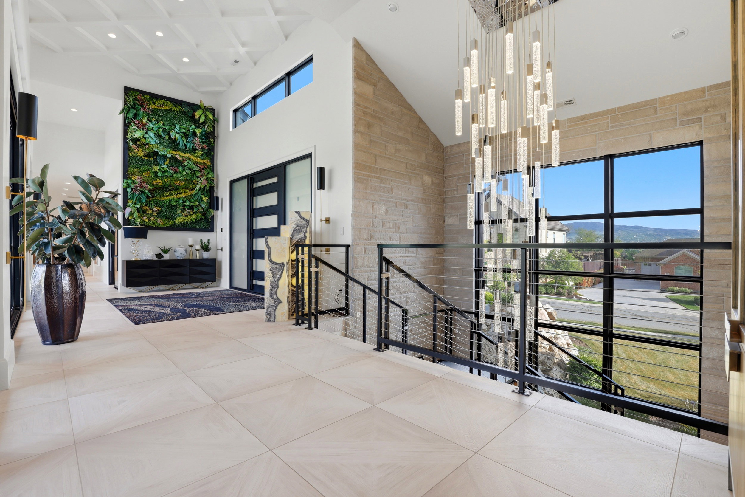 Corridor featuring a high ceiling, an upstairs landing, and recessed lighting