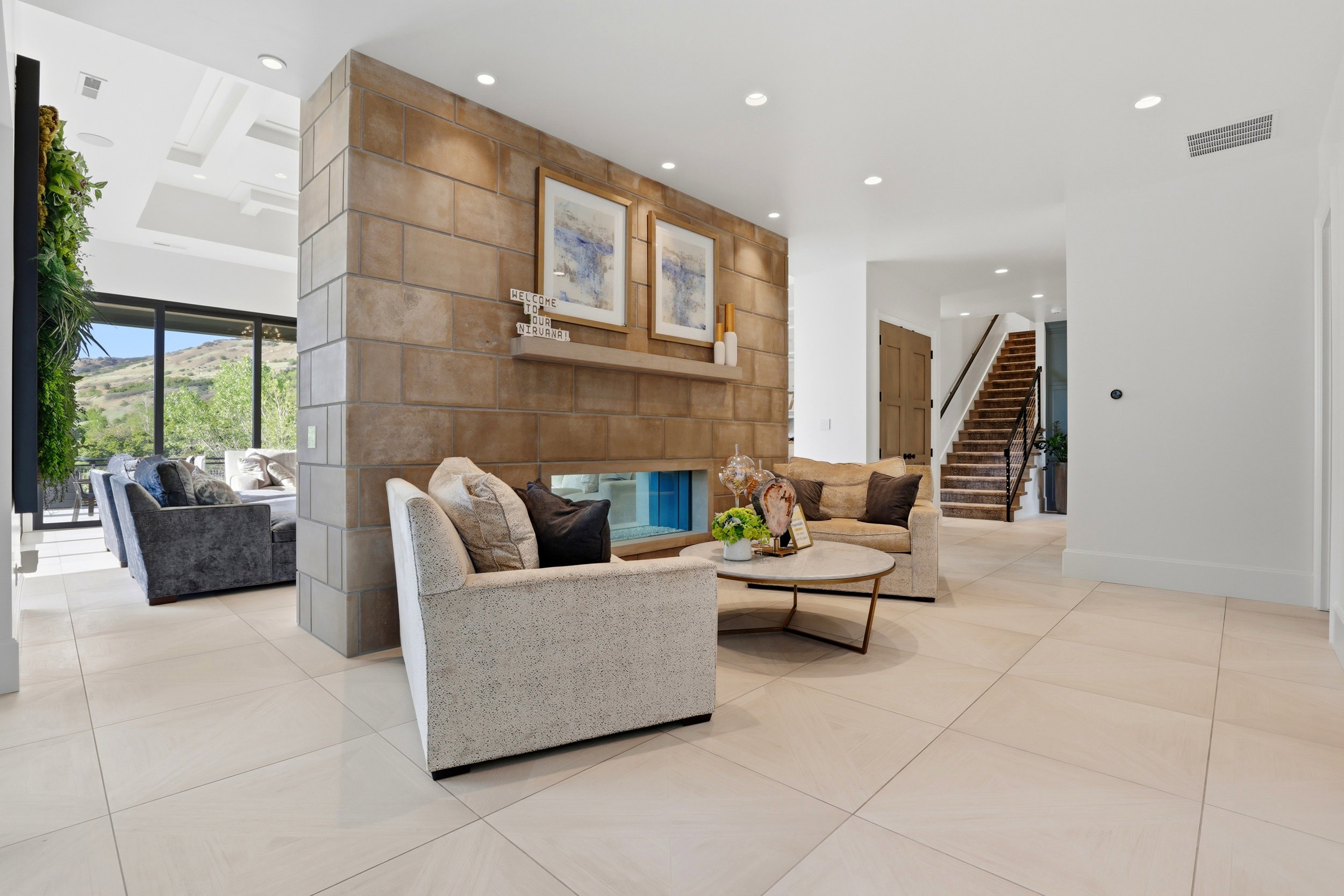 Living room with light tile patterned floors and recessed lighting