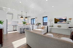 Living area featuring light wood-type flooring, wooden ceiling, and recessed lighting