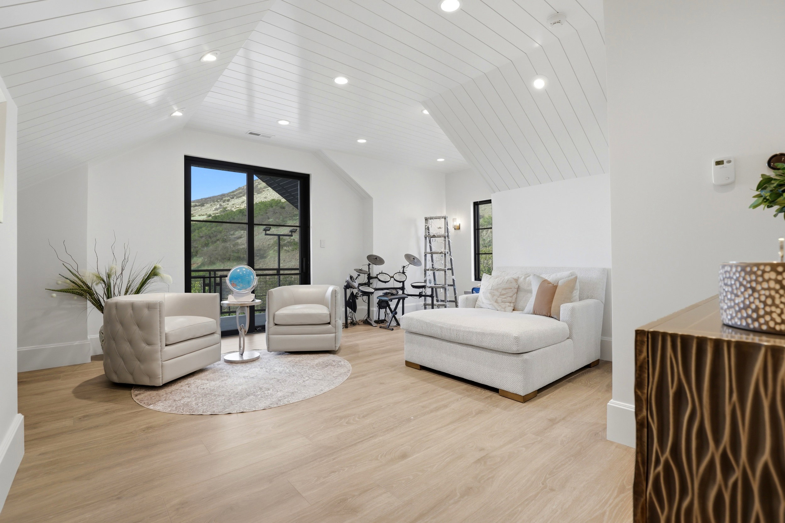 Living room featuring light wood-style flooring, recessed lighting, and a vaulted wooden ceiling