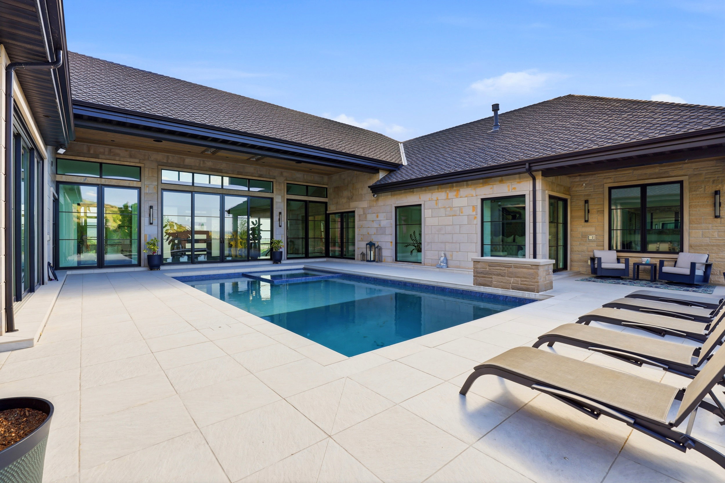 Integrated pool / hot tub featuring a patio area