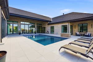 Integrated pool / hot tub featuring a patio area