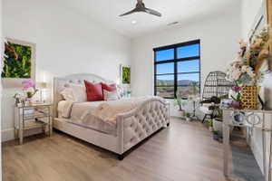 Bedroom featuring light wood-style floors, a mountain view, ceiling fan, and recessed lighting