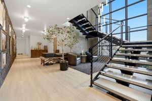 Staircase featuring wood finished floors and recessed lighting