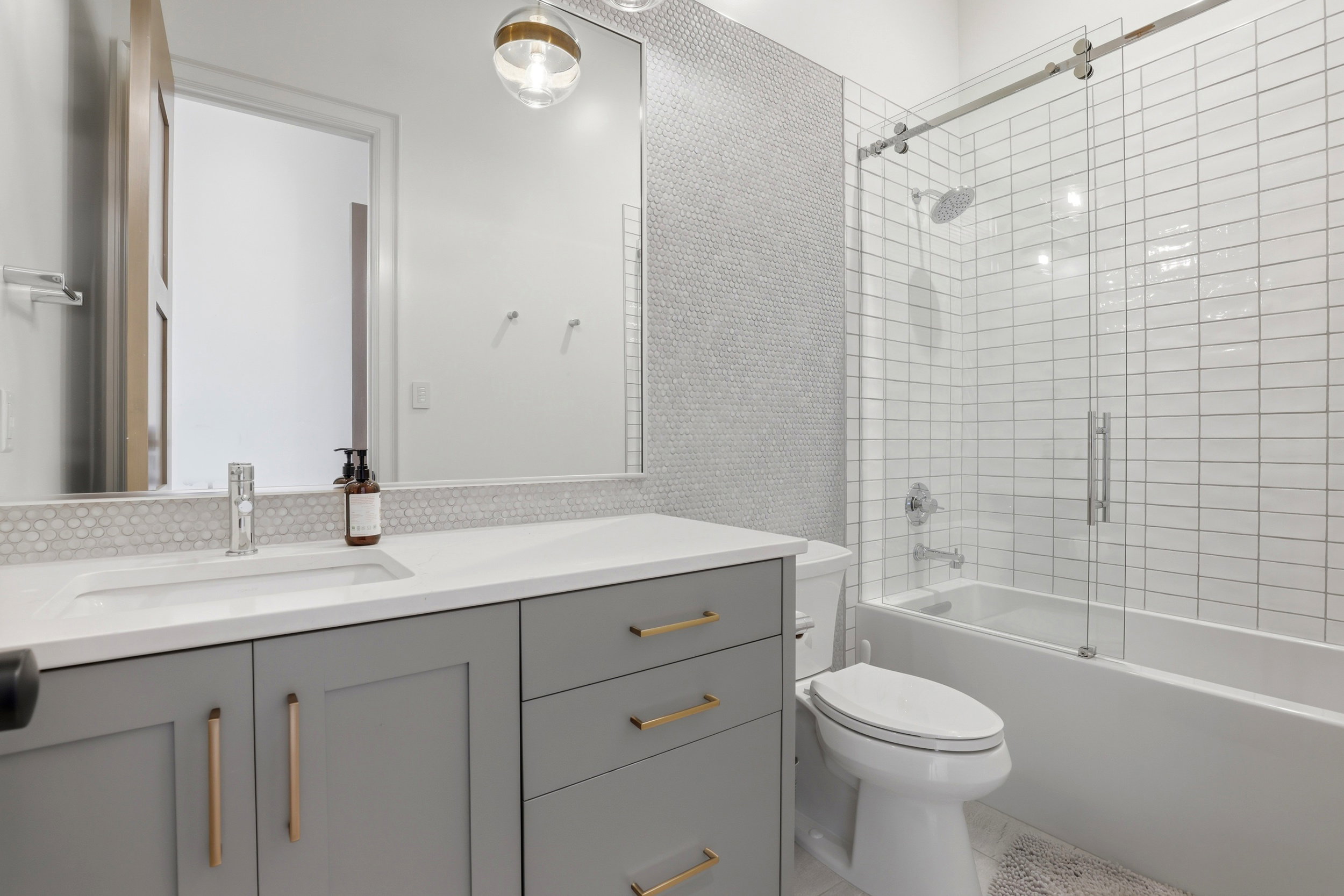 Full bath with vanity and shower / bath combination with glass door