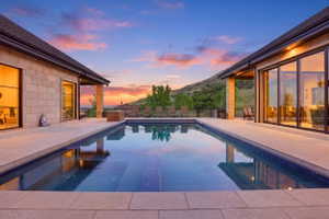 Pool at dusk with a patio area