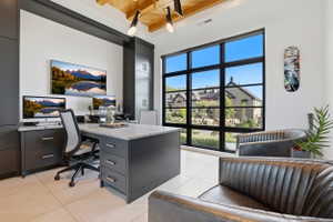 Office space with a wood ceiling with exposed beams and light tile patterned flooring