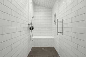 Full bath featuring a tile shower