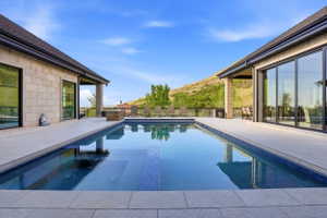 Relaxing pool / spa featuring a mountain view and a patio area