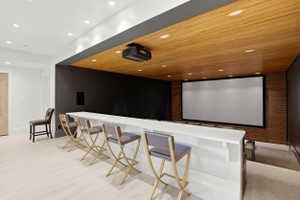Home theater featuring recessed lighting, wood ceiling, and light wood-style flooring