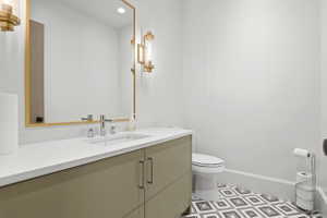 Bathroom with vanity and recessed lighting
