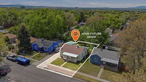 Aerial perspective of suburban area featuring property boundaries highlighted and a heavily wooded area