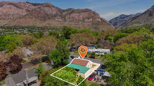 Aerial view of property's location with property parcel outlined and a mountain backdrop