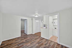 Spare room featuring a textured ceiling and dark wood-style flooring