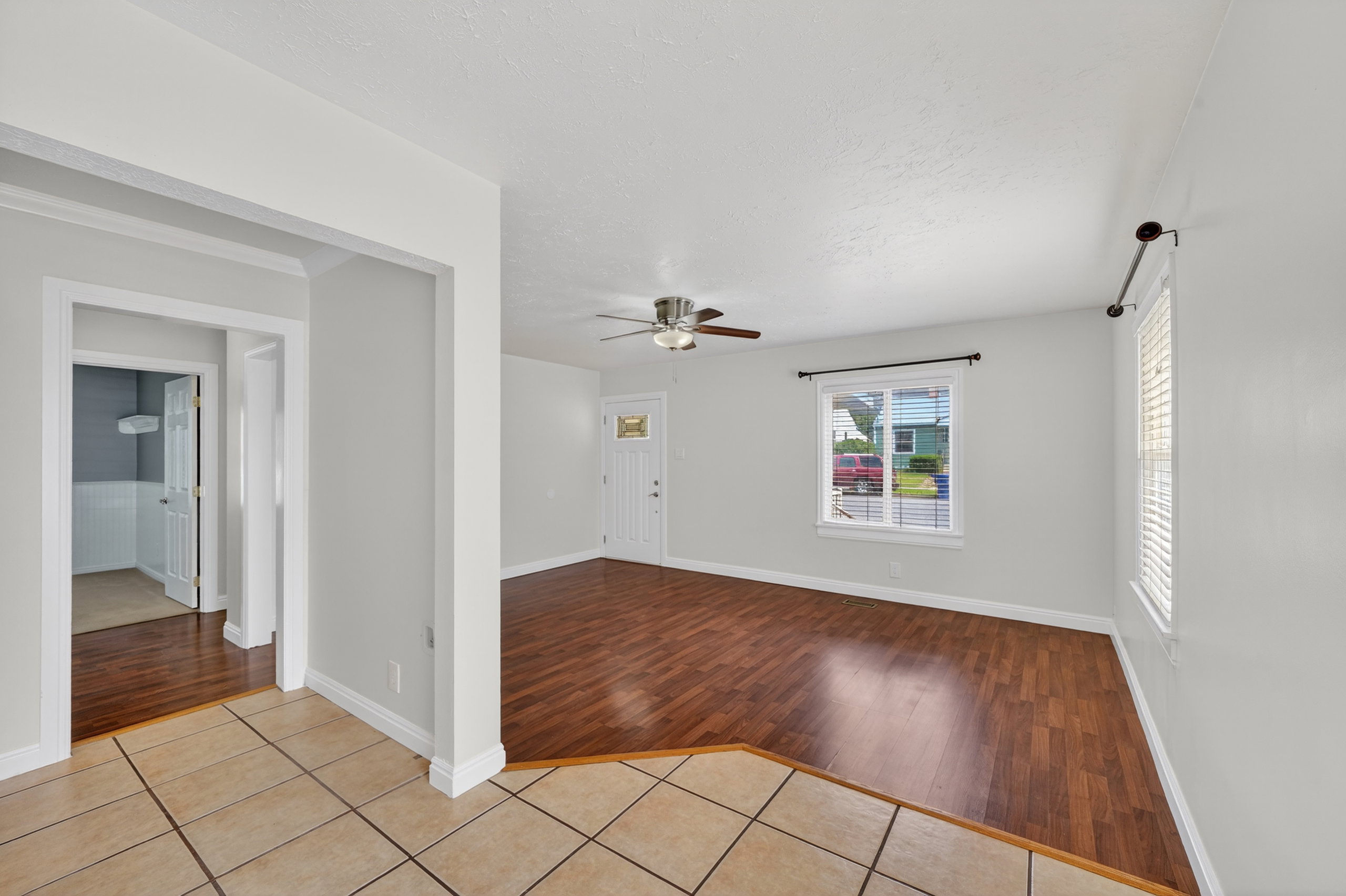 Unfurnished room with light tile patterned floors and ceiling fan