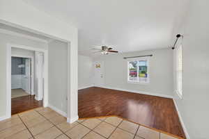 Unfurnished room with light tile patterned floors and ceiling fan