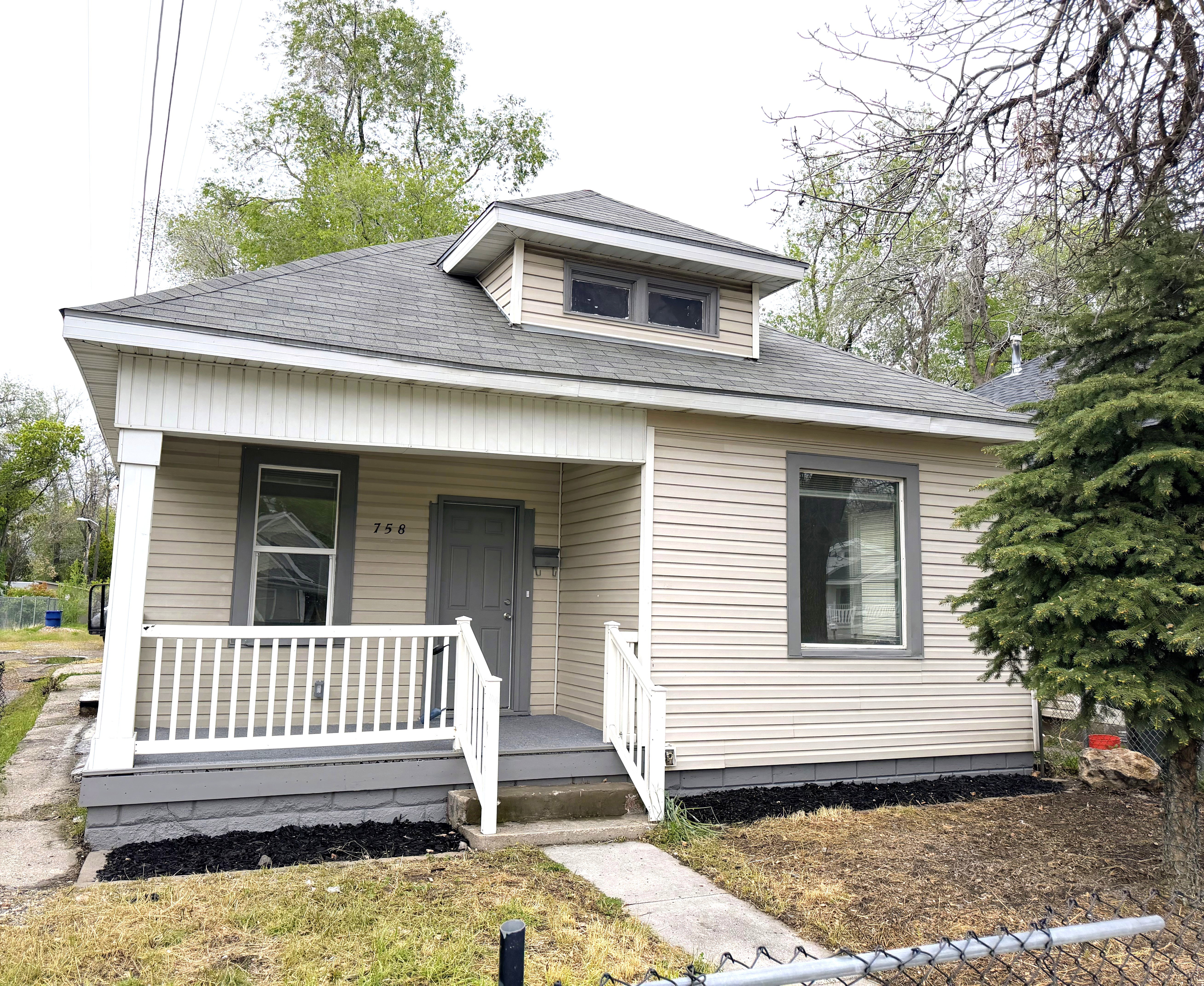 Bungalow-style home featuring covered porch and roof with shingles