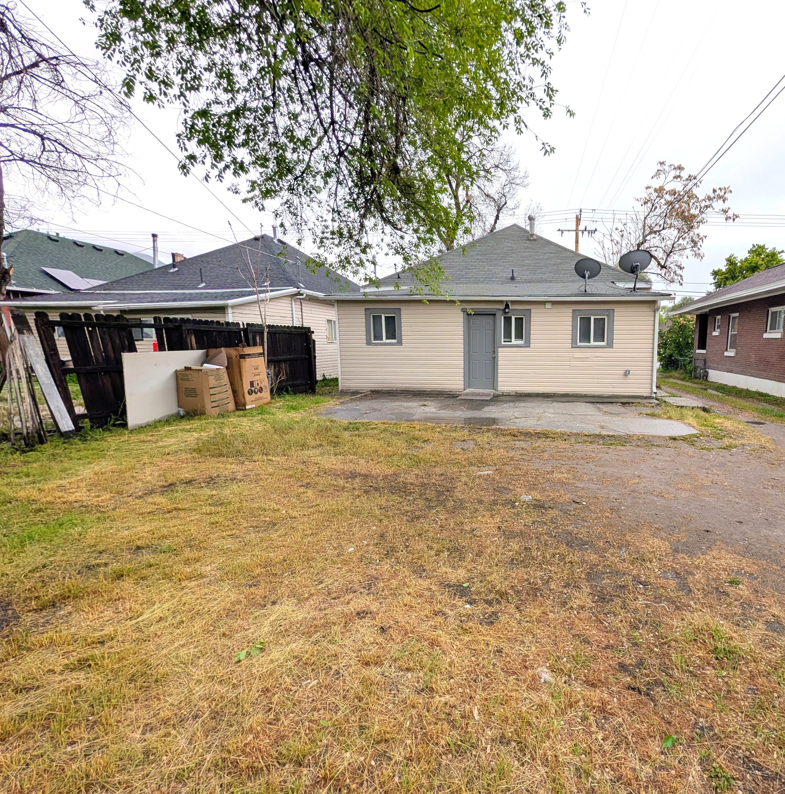 Rear view of house featuring a patio and a yard
