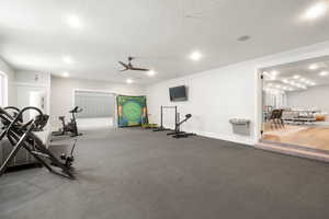Exercise area featuring a ceiling fan, recessed lighting, and a textured ceiling
