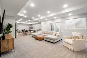Living room featuring light colored carpet and recessed lighting