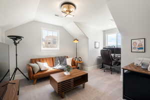 Carpeted home office featuring healthy amount of natural light